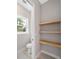 Modern powder room with floating wood shelves and a window at 10750 Sw 110Th St, Dunnellon, FL 34432