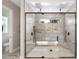 Luxury shower with glass enclosure, dual shower heads, tile surround, and bench at 10750 Sw 110Th St, Dunnellon, FL 34432