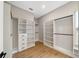 Spacious walk-in closet with custom shelving, drawers, and modern wood flooring at 10750 Sw 110Th St, Dunnellon, FL 34432