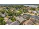 An aerial view showcases the homes of a lakeside community surrounded by beautiful mature trees at 110 Todd Dr, Casselberry, FL 32707