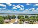 A picturesque lake view with a path leading to a gazebo framed by lush green trees and blue sky at 110 Todd Dr, Casselberry, FL 32707