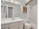 Bathroom featuring a vanity, mirror, toilet, and a shower-tub combo with white tile walls at 110 Todd Dr, Casselberry, FL 32707