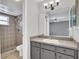 Bathroom featuring updated vanity, mirror and a tiled shower at 110 Todd Dr, Casselberry, FL 32707