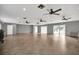Wide, empty hall with tile flooring and ceiling fans, providing a versatile space for various activities at 110 Todd Dr, Casselberry, FL 32707