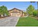 Inviting exterior showcasing a two-car garage, lush green lawn, and beautiful landscaping, enhancing its welcoming charm at 110 Todd Dr, Casselberry, FL 32707
