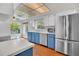 Updated kitchen with stainless steel refrigerator, white cabinets, blue trim, and ample counter space at 110 Todd Dr, Casselberry, FL 32707