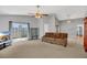 Bright and airy living room featuring a comfortable sofa, sliding glass doors, and open layout, perfect for relaxation at 110 Todd Dr, Casselberry, FL 32707