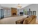 Inviting living room with a stone fireplace, ceiling fan, and sliding door access to the outdoors at 110 Todd Dr, Casselberry, FL 32707