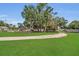 Scenic playground with a winding gravel path, surrounded by lush green grass and mature trees at 110 Todd Dr, Casselberry, FL 32707