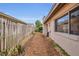 A side yard with wood fence, offering a potential garden or walkway area with wood mulch ground cover at 110 Todd Dr, Casselberry, FL 32707