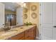 Lovely bathroom featuring a double sink granite vanity, large mirror and a glass shower at 1164 Castle Pines Ct, Reunion, FL 34747