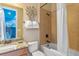Bathroom featuring a shower-tub combo, vanity with decorative mirror, and a toilet at 1164 Castle Pines Ct, Reunion, FL 34747