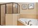 Bright bathroom featuring a shower and soaking tub with tile surround, complemented by elegant fixtures and finishes at 1164 Castle Pines Ct, Reunion, FL 34747