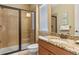 Clean bathroom with a glass-enclosed shower, granite vanity and tiled floors at 1164 Castle Pines Ct, Reunion, FL 34747
