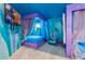 Enchanting Frozen-themed bedroom with bed canopy, custom mural, and cozy chair at 1164 Castle Pines Ct, Reunion, FL 34747