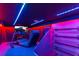 Themed bedroom with blue LED lighting, racing video game setup, and custom shelving at 1164 Castle Pines Ct, Reunion, FL 34747