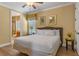 Comfortable bedroom with a queen size bed, wood floors and adjacent bathroom at 1164 Castle Pines Ct, Reunion, FL 34747