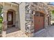 Charming home exterior with stone accents, brick walkway, and two-car garage at 1164 Castle Pines Ct, Reunion, FL 34747