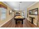 Spacious game room featuring a billiards table, comfortable couch and stylish decor at 1164 Castle Pines Ct, Reunion, FL 34747