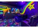 Bright game room with custom Mario Kart themed artwork on the walls at 1164 Castle Pines Ct, Reunion, FL 34747