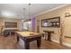 Game room featuring a pool table, lounge seating, and stylish decor, perfect for entertaining guests and Gathering at 1164 Castle Pines Ct, Reunion, FL 34747