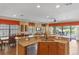 Gourmet kitchen featuring granite countertops and stainless steel appliances overlooks the dining area and living room at 1164 Castle Pines Ct, Reunion, FL 34747