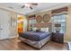 Comfortable main bedroom suite featuring a neutral color palette, plush bedding, and a private ensuite bathroom at 1164 Castle Pines Ct, Reunion, FL 34747