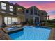 Inviting pool area with a jacuzzi, lounge chairs and views of the home's rear exterior at 1164 Castle Pines Ct, Reunion, FL 34747