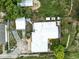 Aerial view of the property featuring the main house, guest house, firepit and solar panels at 130 Masterpiece Rd, Lake Wales, FL 33898