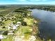 Picturesque aerial shot of houses nestled beside a serene lake and lush green landscape at 130 Masterpiece Rd, Lake Wales, FL 33898