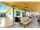 Inviting covered back porch with comfortable seating and outdoor lighting at 130 Masterpiece Rd, Lake Wales, FL 33898