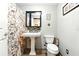 Bathroom with pedestal sink, tiled floors and shower at 130 Masterpiece Rd, Lake Wales, FL 33898