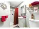 Cozy bathroom with a walk-in shower, pedestal sink, and decorative mirror at 130 Masterpiece Rd, Lake Wales, FL 33898
