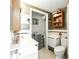 Functional bathroom with a vanity, toilet, and built-in shelving for storage at 130 Masterpiece Rd, Lake Wales, FL 33898