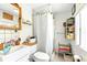 Cozy bathroom with a white shower curtain, tile flooring and a white sink at 130 Masterpiece Rd, Lake Wales, FL 33898