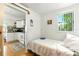 Small bedroom adjacent to the kitchen featuring a single bed, hardwood floors, and a window at 130 Masterpiece Rd, Lake Wales, FL 33898