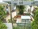 Inviting outdoor courtyard with a pergola, garden, and charming picnic table at 130 Masterpiece Rd, Lake Wales, FL 33898