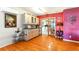 Dining area with wood floors, bar with counter, and sliding doors to the kitchen at 130 Masterpiece Rd, Lake Wales, FL 33898