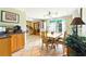 Bright dining area with tile floor, sliding glass doors, and a kitchen nook with wood cabinets and stainless steel appliances at 130 Masterpiece Rd, Lake Wales, FL 33898