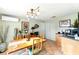 Dining area featuring a light fixture, wood table with chairs, and a view of kitchen cabinets and storage at 130 Masterpiece Rd, Lake Wales, FL 33898