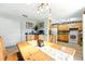 Open dining area features wood table and chairs, and leads into the kitchen with wood cabinets and white appliances at 130 Masterpiece Rd, Lake Wales, FL 33898