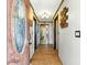 Entryway with stained-glass door, wood-look tile floors, and decorative wall art at 130 Masterpiece Rd, Lake Wales, FL 33898