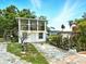 Charming two-story home with front porch and exterior staircase surrounded by lush landscaping at 130 Masterpiece Rd, Lake Wales, FL 33898