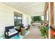 Relaxing front porch with seating, plants, and view of natural surroundings at 130 Masterpiece Rd, Lake Wales, FL 33898