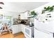 Bright kitchen features white appliances, white cabinets, and a window with greenery at 130 Masterpiece Rd, Lake Wales, FL 33898
