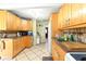 Bright kitchen featuring tiled floor, wood cabinetry, and stainless steel sink at 130 Masterpiece Rd, Lake Wales, FL 33898