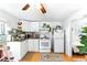 Bright kitchen featuring white cabinetry, white appliances, and lots of storage space at 130 Masterpiece Rd, Lake Wales, FL 33898