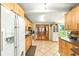 Spacious kitchen with white appliances, light-wood cabinetry and tile flooring at 130 Masterpiece Rd, Lake Wales, FL 33898