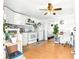 Cozy kitchen featuring white cabinets and appliances adjacent to a small office area at 130 Masterpiece Rd, Lake Wales, FL 33898