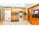 Kitchen with wooden cabinets, tile floors, and open view of adjoining Gathering room at 130 Masterpiece Rd, Lake Wales, FL 33898